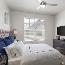 Sleep soundly and wake up feeling refreshed in our cozy bedroom at Springville Oaks. bedroom with a tv and a large window