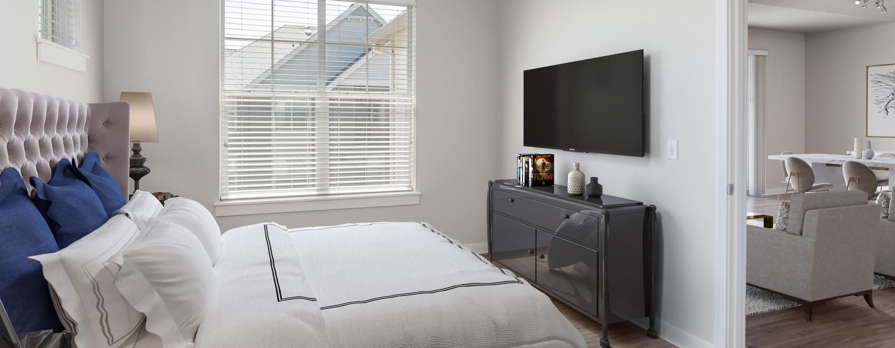 a bedroom with a large window and easy access to the living room
